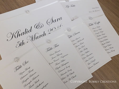 table plan cards in ivory with a pearl and satin ribbon